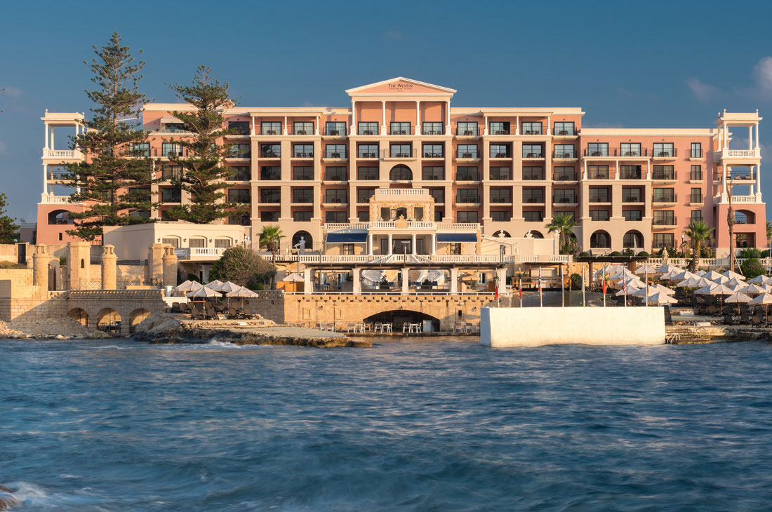 地中海にピンクが映えるホテル外観